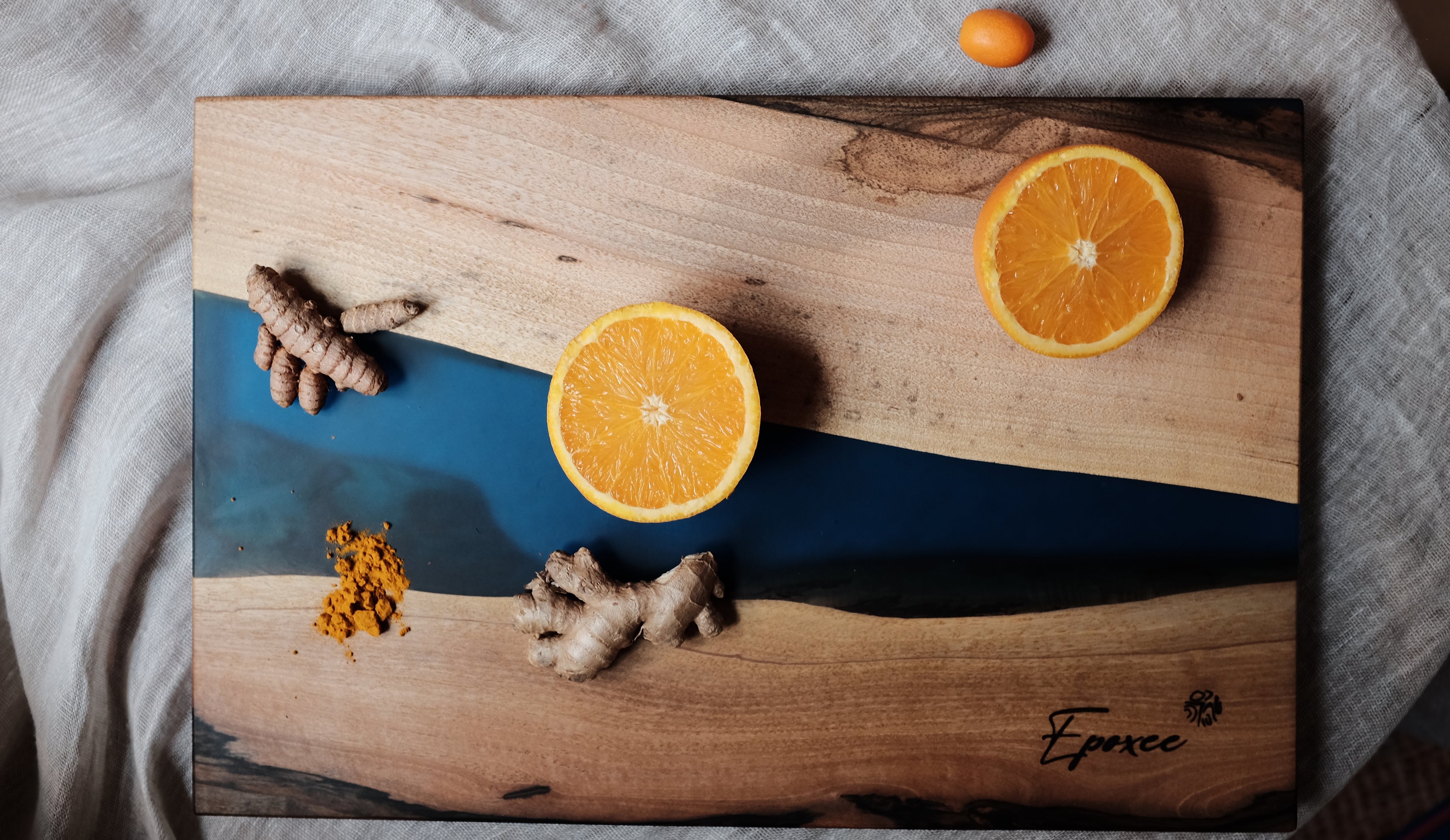 Blue epoxy wooden board with decorative oranges on top - showcasing exquisite craftsmanship and vibrant design