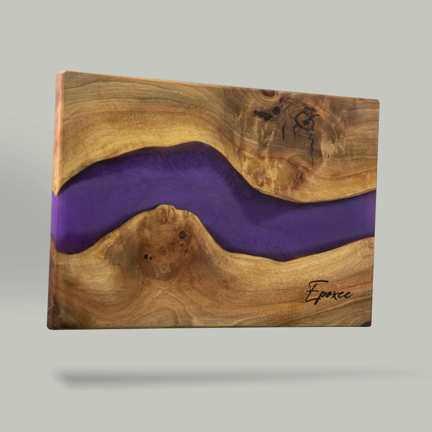 Serving board made from wood and epoxy resin in the color purple