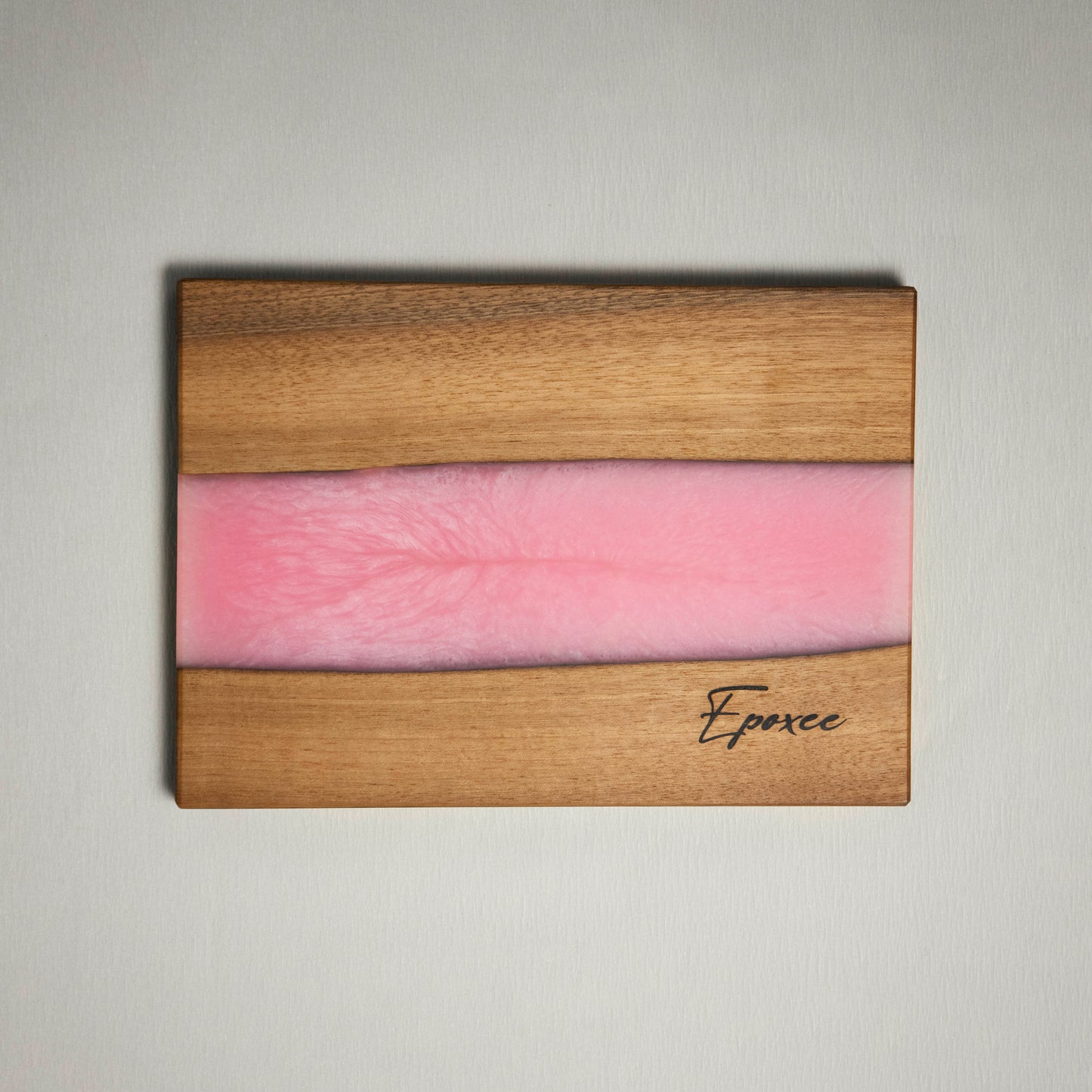 Serving board made from wood and epoxy resin in the color rose quartz