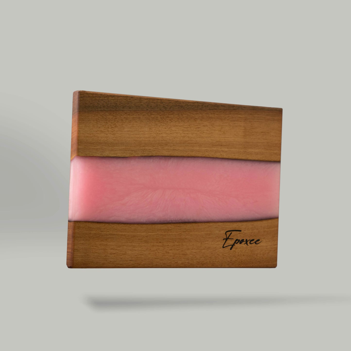 Serving board made from wood and epoxy resin in the color rose quartz