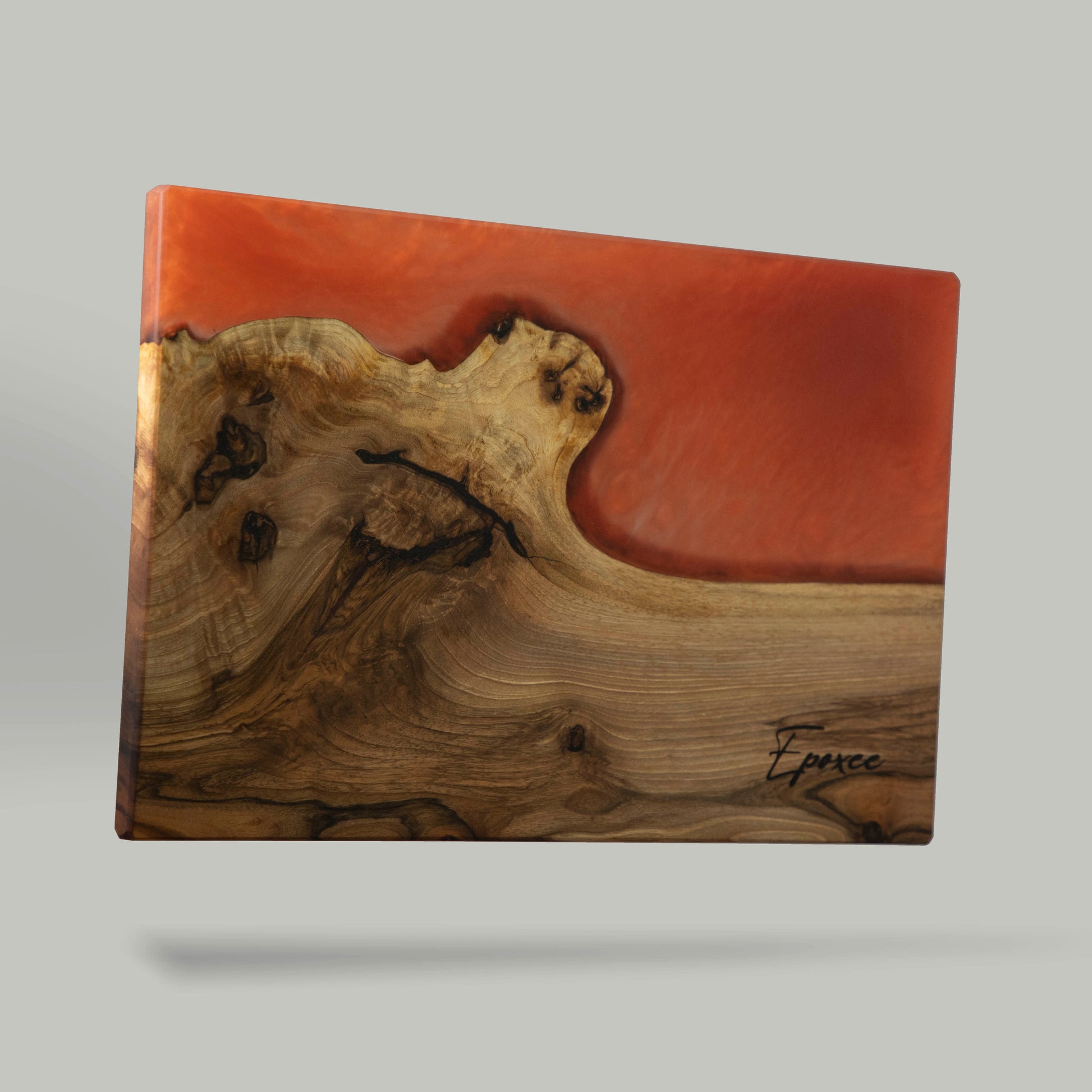 Serving board made from wood and epoxy resin in the color siena orange