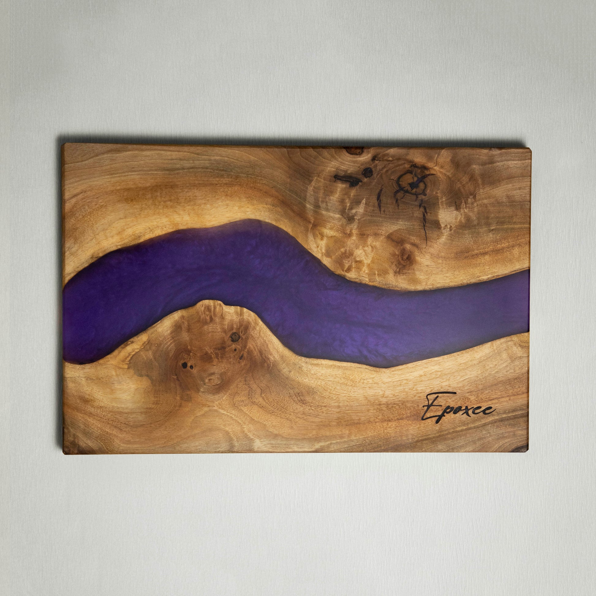 Serving board made from wood and epoxy resin in the color purple