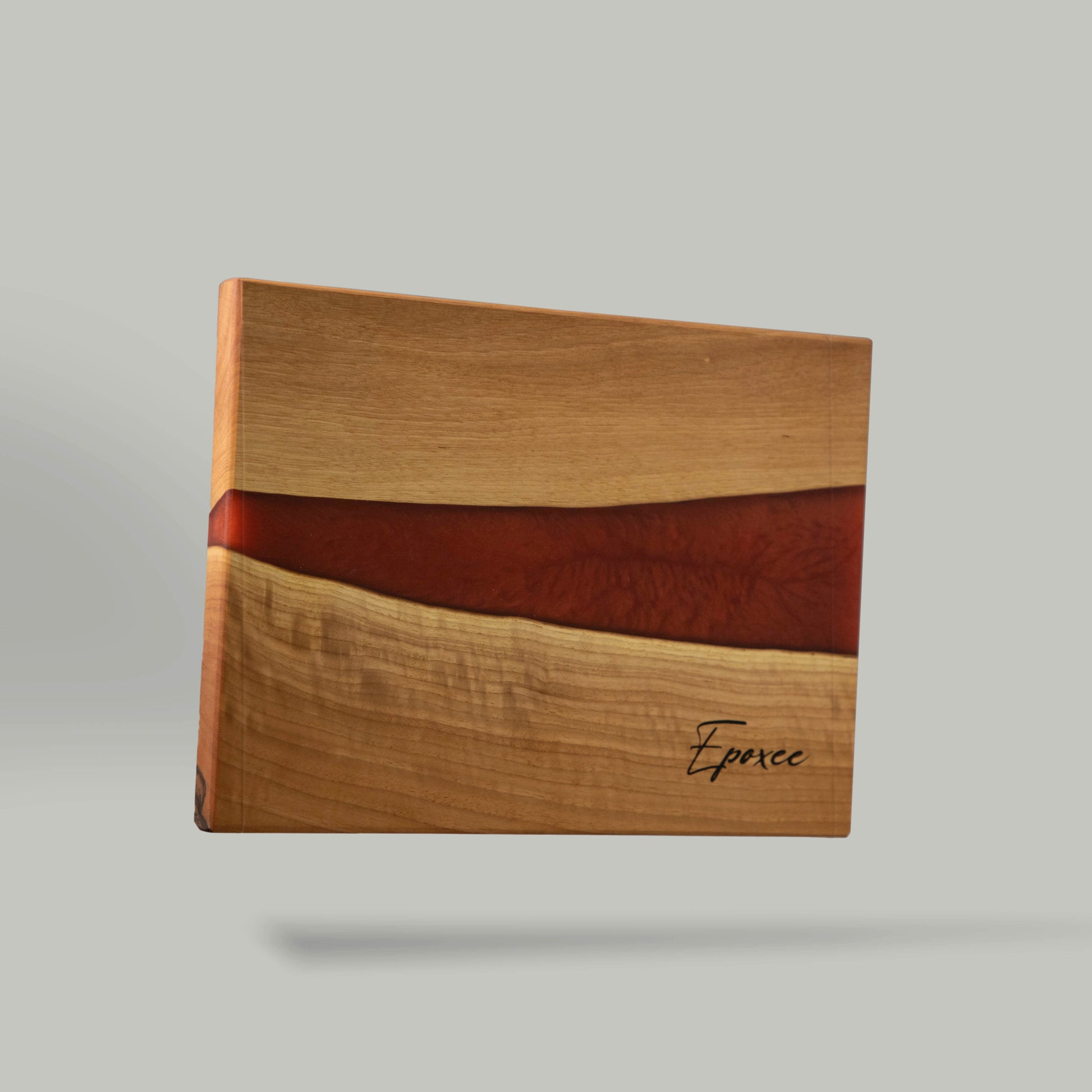 Serving board made from wood and epoxy resin in the color red orange