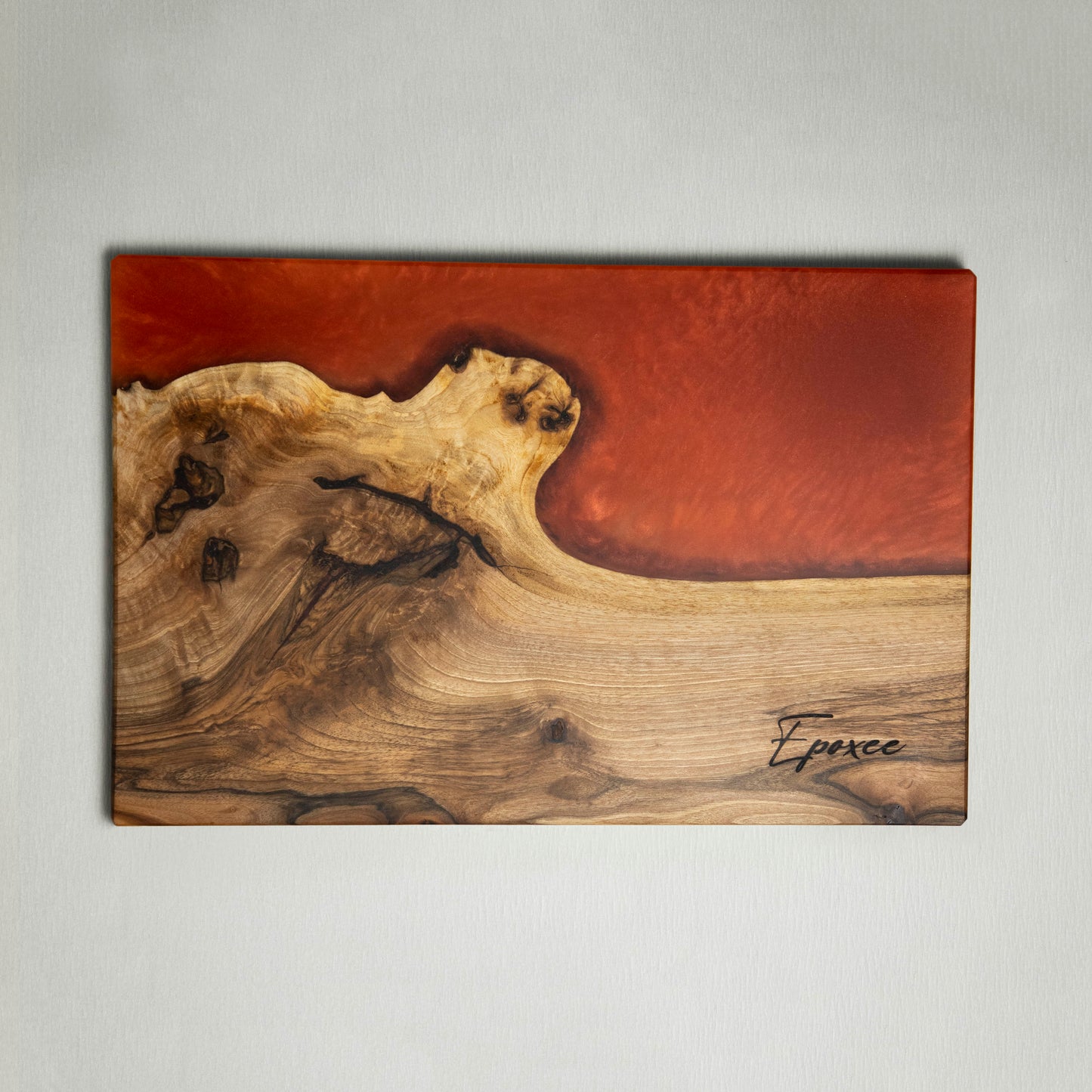 Serving board made from wood and epoxy resin in the color siena orange